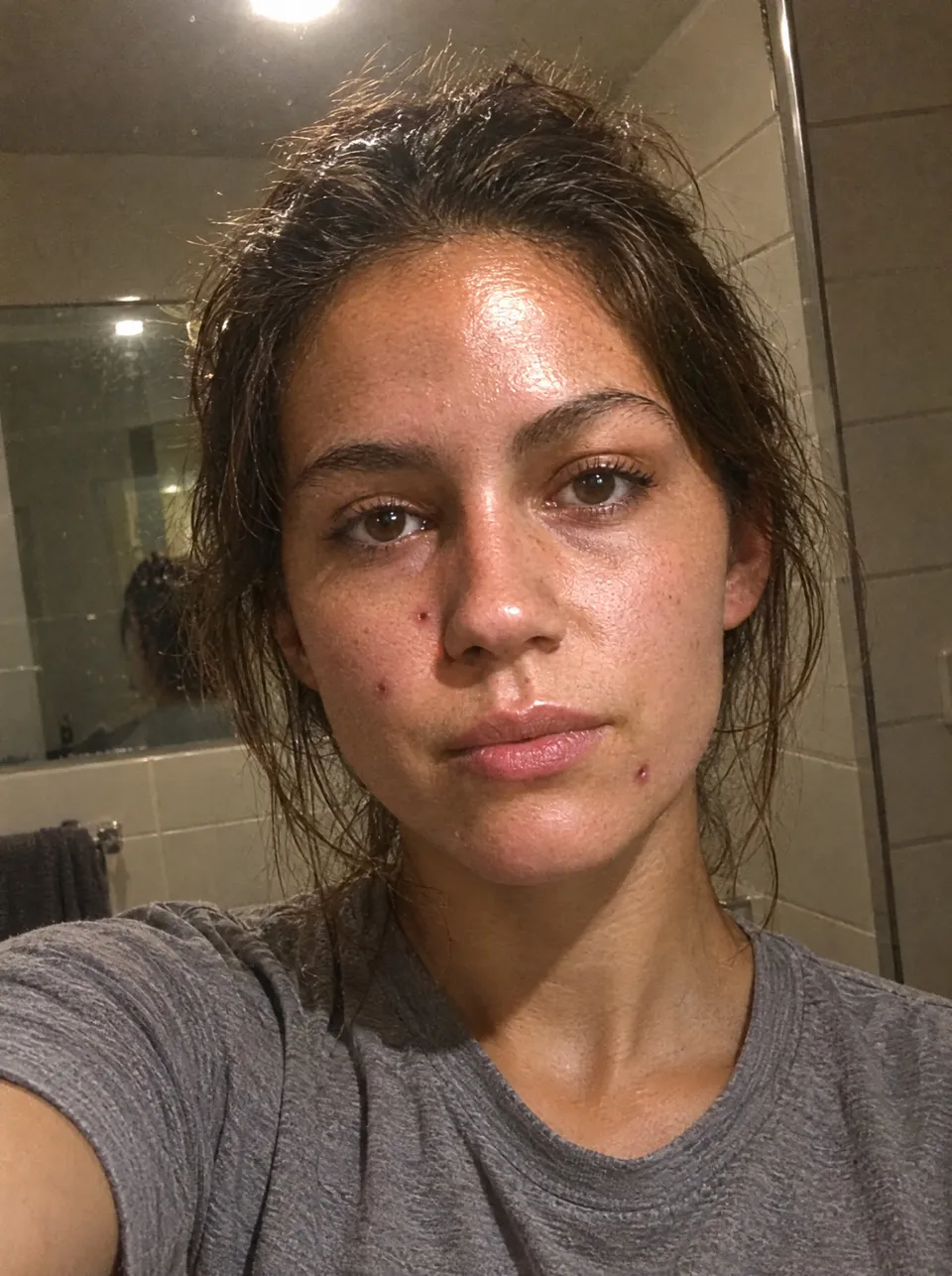 Woman in harsh bathroom light